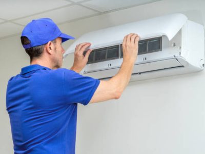Hvac technician performing air conditioner maintenance inspection. 24 hours emergency air conditioning breakdowns and failures repair service. Home insurance.